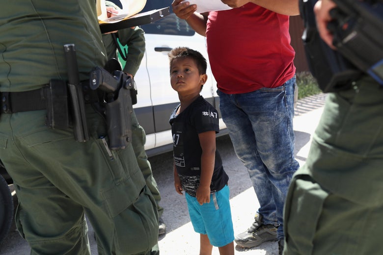 A boy and father from Honduras are taken into custody by Border Patrol agents near the U.S.-Mexico Border on June 12, 2018 near Mission, Texas.